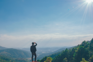 Man Looking From a Cliff at Mountains and Horizon